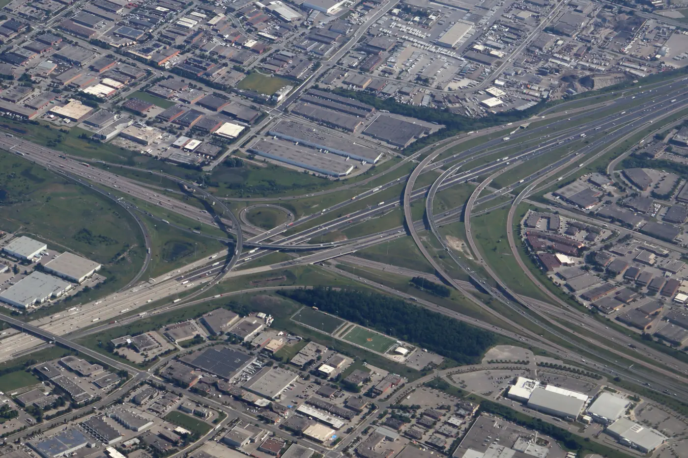 Aerial view of a major highway interchange surrounded by industrial buildings
